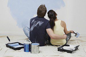 Couple painting their walls light blue