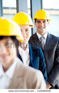 Photo of construction professionals wearing yellow gard hats