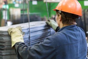 Photo of metal worker wearing orange hard hat