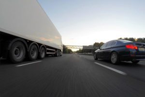 Photo of a tractor trailer and SUV in parking lot