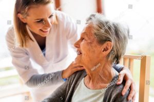 Photo of nurse speaking to older lady in healthcare setting