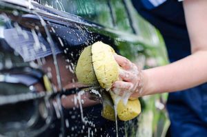 Photo of someone washing a car - Links to auto insurance page