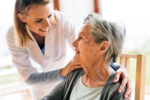 Photo of nurse speaking to older lady in healthcare setting