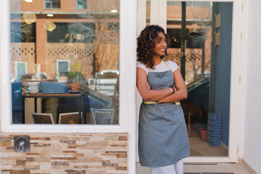 Businessowner standing in their entrance contemplating what business insurance actually covers