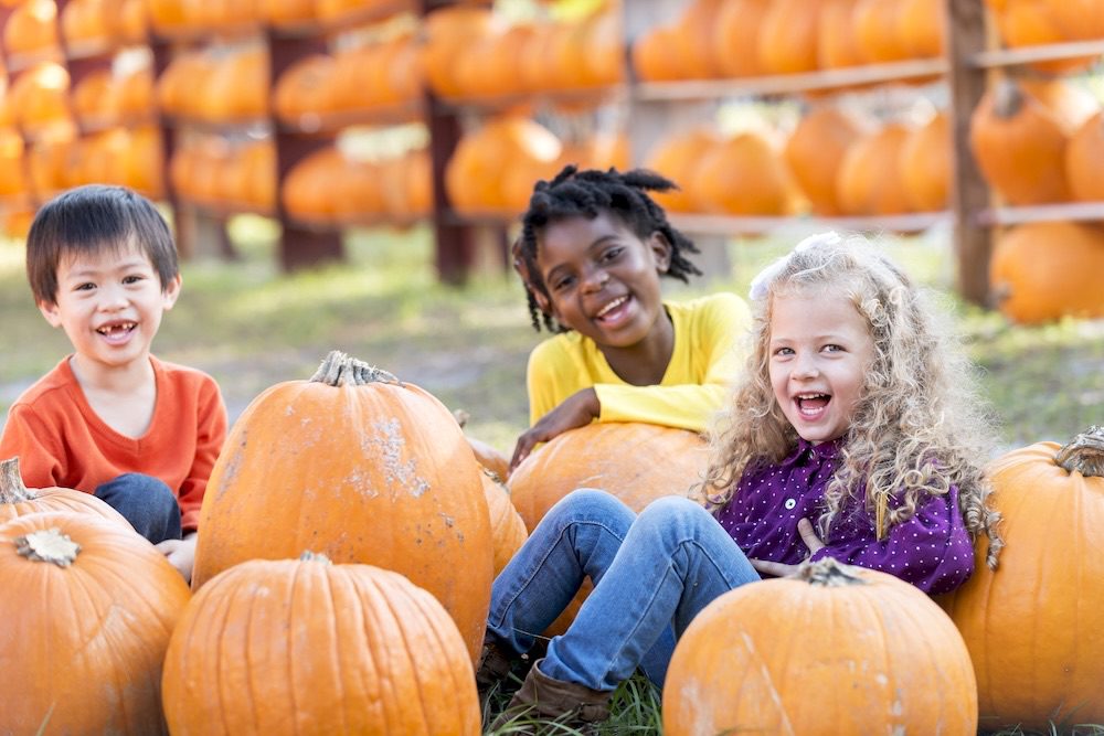 Gilbert-Blog-Haunted-Happenings-Local-Fall-Events-for-Whole-Family-Featured-Image Image of three happy children in a pumpkin patch